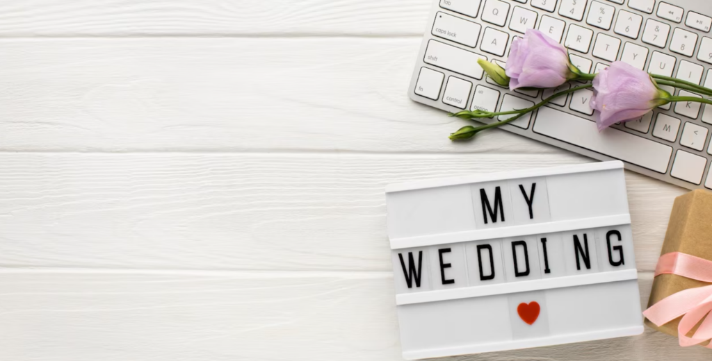 my wedding words with red heart, two purple flowers on white keyboard, small box with pink ribbon